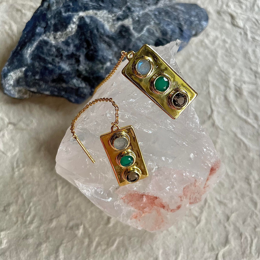 An unusual design ear wire design, but surely received very well. A one-inch gold plated earring that holds labradorite, a green onyx, and a smoky quartz gemstone, all being 5 mm in size so intricately that it is hard to resist wearing it and flaunting it right away. Simply slide it in and choose the length of the earring you desire!