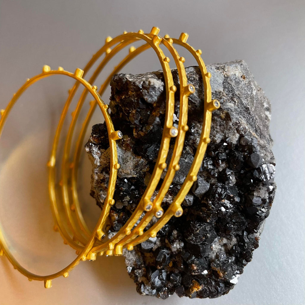 Dainty, sleek, and petite, these beautifully textured bangle bracelet with gold plating is a loveable everyday piece of jewelry, that you would not want to ever remove.   Wear it alone or stack a couple of these bracelets together, or better yet match them with other bracelets/cuffs from Mia Siya to create a unique set that creates the most adorable jingling sound. These 'NO weight' bangle bracelets are a 'must have' be it for work or evening wear. Versatile and comfortable to wear all day long.