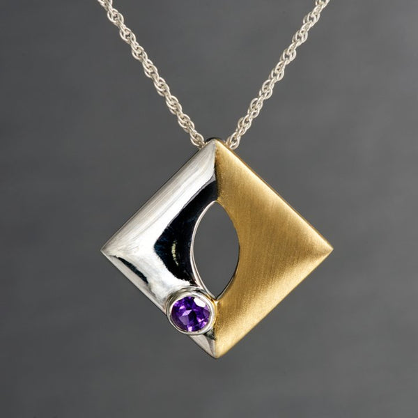 A square-shaped, but when worn it looks more of a diamond-shaped pendant is, two toned-sterling silver on one side and sterling silver with gold plating on the other side. It has a 4mm amethyst gemstone which is embedded with perfection and finesse