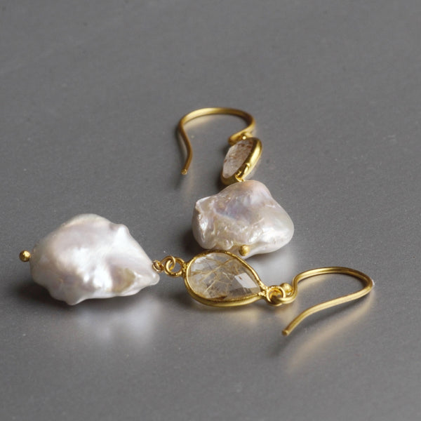 Free-spirited with a dancing soul, these unusually shaped baroque pearl dangle earrings, are eye candies to a girl's heart.  Enhanced with a labradorite gemstone on top, which is a stone of magic, a crystal of shamans, diviners, healers, and all who travel and embrace the universe seeking knowledge.  The clients' favorite choice is the most 'unique gift set' from Mia Siya which is often addressed as the most popular design.