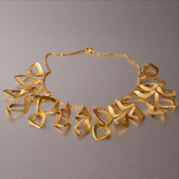 A piece of jewelry that has been raved with numerous compliments ever since it was introduced in 2015. Feather weight, flimsy yet durable and sturdy. Hand hammered necklace with18kt gold plating. An elegant, refined and sophisticated piece of jewelry. 