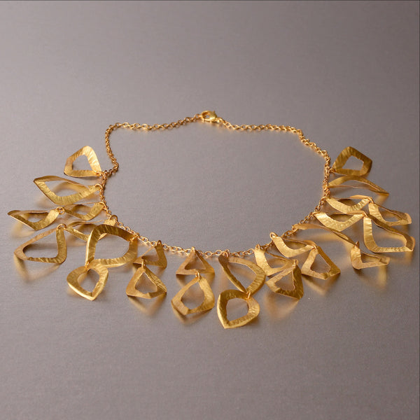 A piece of jewelry that has been raved with numerous compliments ever since it was introduced in 2015. Feather weight, flimsy yet durable and sturdy. Hand hammered necklace with18kt gold plating. An elegant, refined and sophisticated piece of jewelry.