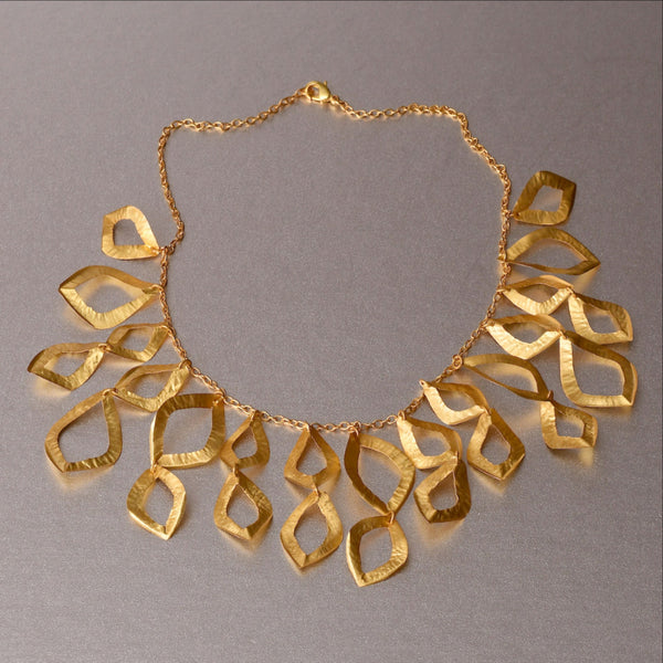 A piece of jewelry that has been raved with numerous compliments ever since it was introduced in 2015. Feather weight, flimsy yet durable and sturdy. Hand hammered necklace with18kt gold plating. An elegant, refined and sophisticated piece of jewelry.