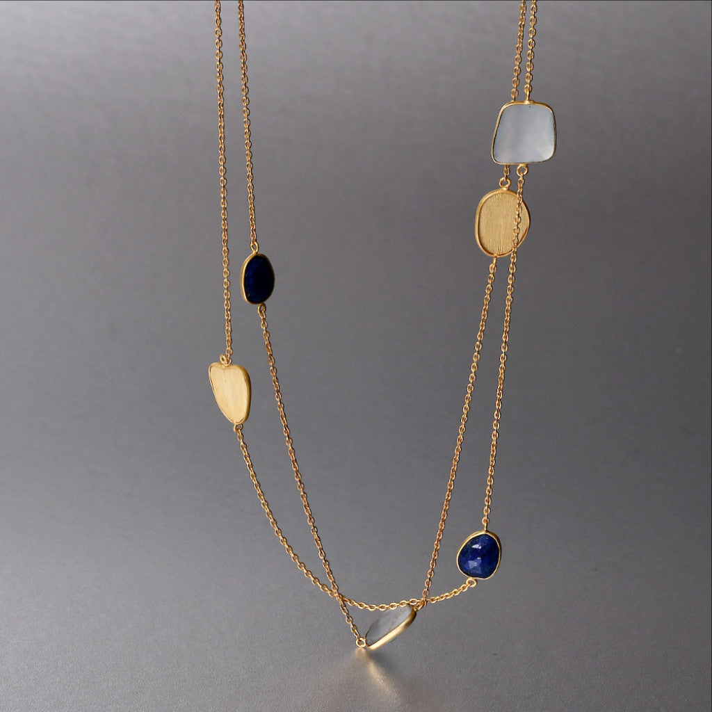 An everyday 20 1/2 inch layer 'Maia Necklace' with fine lapis lazuli and blue chalcedony gemstones brings that splash of color and style your attire may just need.