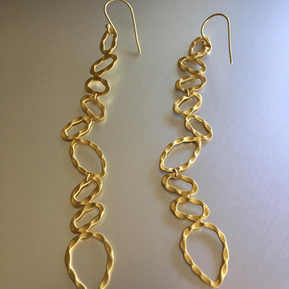 These gold plated over sterling silver, featherweight, almost 2 inches long, chic earrings are quite deceiving for they may seem heavy but are 'featherweight'. An elongated and preppy shape that will spruce any attire.