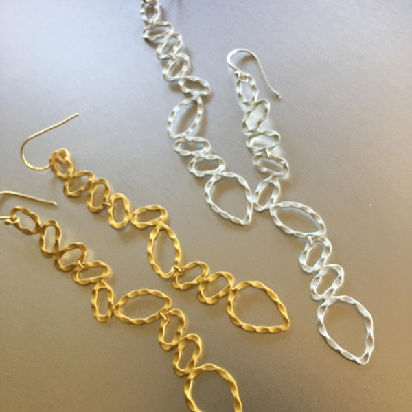 These gold plated over sterling silver, featherweight, almost 2 inches long, chic earrings are quite deceiving for they may seem heavy but are 'featherweight'. An elongated and preppy shape that will spruce any attire.