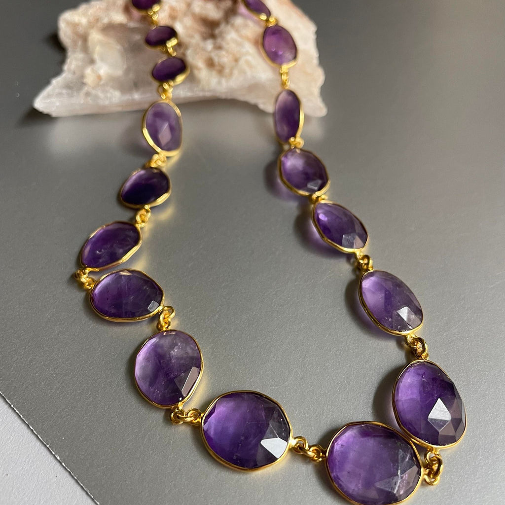 25.56 gms of total weight, this unique 9-inch amethyst necklace in brass with gold plating is mesmerizingly beautiful. Unshaped 19 amethyst strung together with poise and finesse.  With 97.600 gms total weight of amethyst, it is a sheer luxury that one must possess.