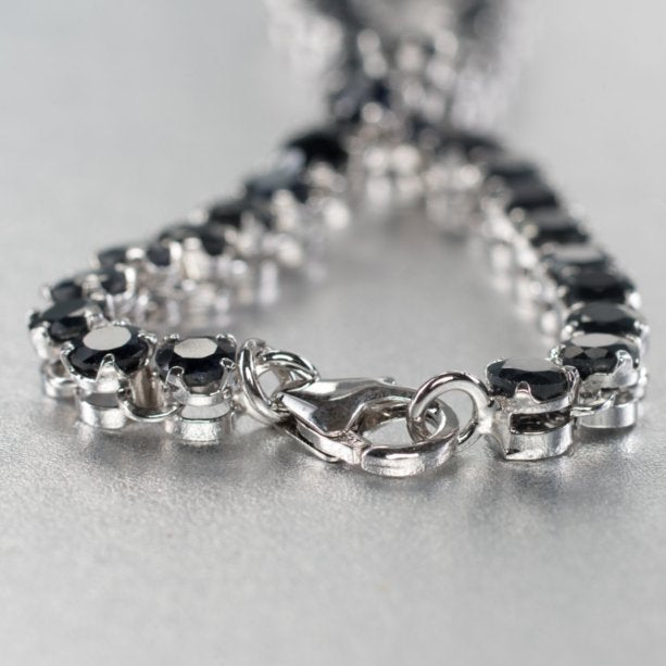 A breathtaking 7 and 3/4 inch sterling silver bracelet set gracefully with 37 blue sapphire gemstones