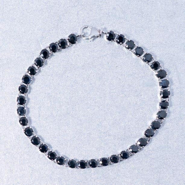 A breathtaking 7 and 3/4 inch sterling silver bracelet set gracefully with 37 blue sapphire gemstones