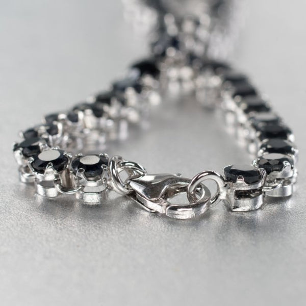 A breathtaking 7 and 3/4 inch sterling silver bracelet set gracefully with 37 blue sapphire gemstones