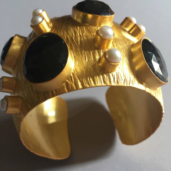 If I may say so myself, this exquisite, chunky gold cuff with black onyx and pearls is simply spectacular. One glance at it gets you hypnotized to a point of owning it and glamourizing it on your wrist