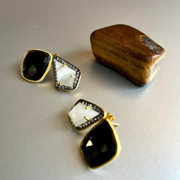 A beautiful amalgamation of black onyx and moonstone is strikingly beautiful with the addition of cubic zirconia to add that perfect bling. The unshaped black onyx is 13x15 and carries a weight of 13.77mm and the moonstone on the other day, also unshaped is 10 x 15 and weighs 6.29mm.  A sophisticated pair of earring studs that can lean from work to evening wear in the blink of an eye.