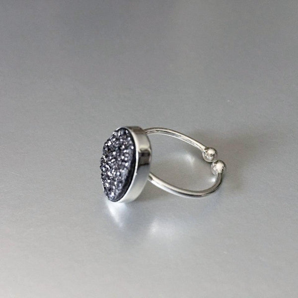 Adjustable, sterling silver, open ring with stunning sparkling black druzy adds an artful addition to your everyday look.