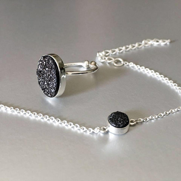 Adjustable, sterling silver, open ring with stunning sparkling black druzy adds an artful addition to your everyday look.