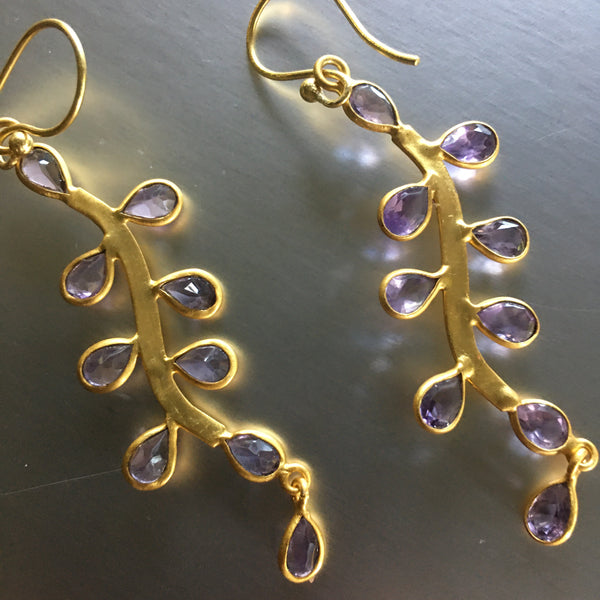 Looks can be deceiving! The saying can easily be used for these stunning Sanya Earrings with amethyst. Lightweight, delicate yet durable and bold, these playful earrings showcase amethyst gemstones so graciously that one may not imagine