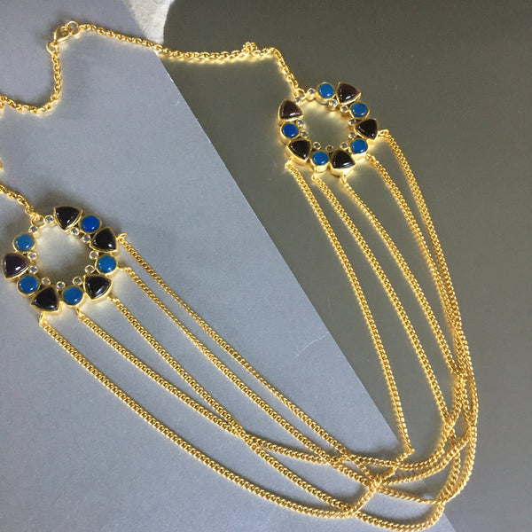 A playful necklace that may just hold your breath and keep it there for a while. An exceptional design that exudes sophistication and elegance. A chunky necklace with 2 medallions on each side flaunts a style that is unique and mysterious. Embedded with amethyst, blue chalcedony, and cubic zirconia for that perfect bling. 5 gold plated intertwined chains hung loosely and freely.