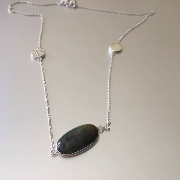 Dainty as can be, this flimsy yet durable sterling silver chain necklace with an adorable designed charm on each side and a glistening, striking labradorite pendant.