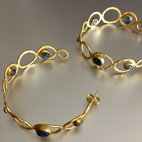 One of my personal favorite to look at since I can't wear anything more than a stud. A lover of jewelry, especially earrings but can't wear it but you can. Enjoy these stunning gold plated semi-hoop, enhanced with my favorite gemstones: labradorite. What can be more breathtakingly beautiful than that combination?