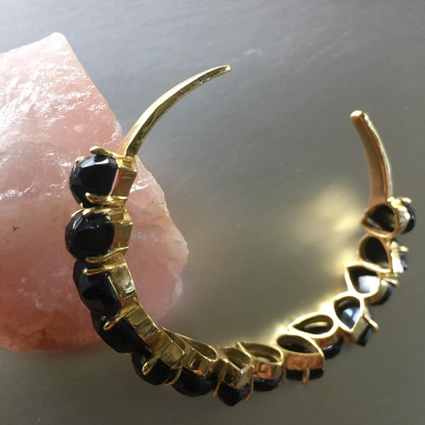 Lyala cuff brings together elements such as the black onyx gemstone, which are distributed evenly from one end to the other and gold plated cuff, the combination of which exudes elegance and finesse. The weight is to the minimal, which one wouldn't expect and the wear is super comfortable.