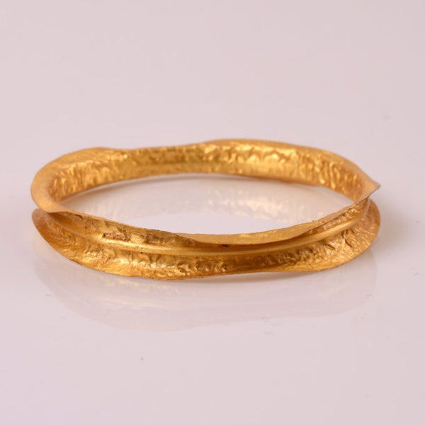 Some jewelry pieces need no description, literally! Stack them together OR wear them individually. Lightweight bangle/bracelet with 18kt gold plating. Showcasing an artistic and mysterious vibe, these bangles are glamorous, charismatic and has a playful characteristic to it. A lightest sheet of metal is molded and hammered to give it a unique earthy rustic texture.
