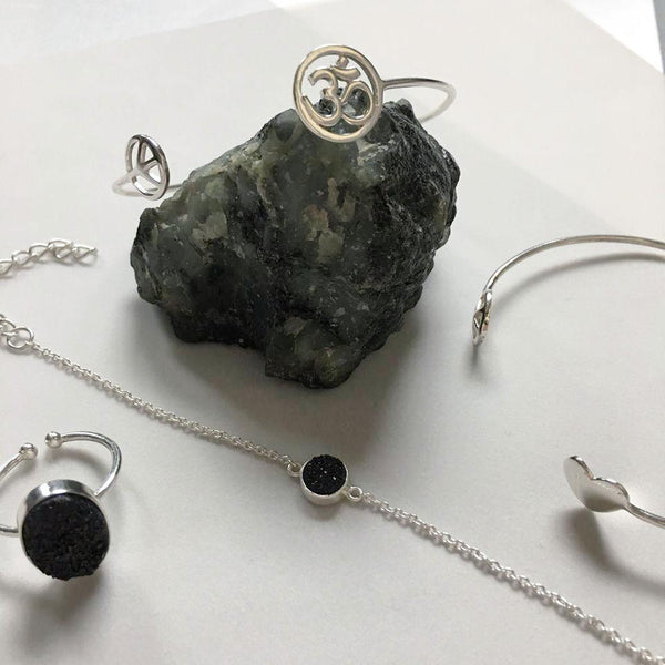 An adjustable, dainty, lightweight, sterling silver bracelet with stunning sparkling black druzy adds an artful addition to your everyday look. Druzy quartz is a stone material that is relatively inexpensive and beautiful when used in jewelry. It is a popular choice because of its sparkle and color and can readily be cut into interesting and unusual shapes.