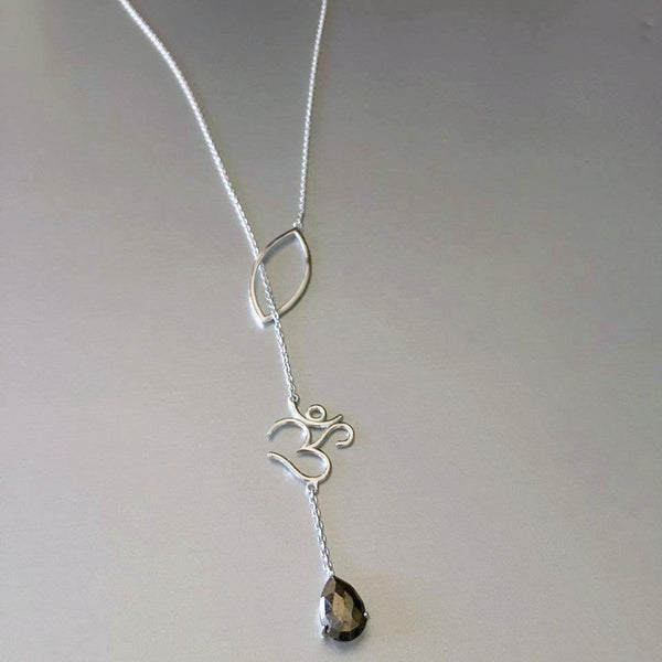 The most unusual design from the new collection: The lariat necklace. What better choice of pendant and charm than an "OM" with a smoky quartz gemstone. The delicate sterling silver chain goes through gracefully via the petal thereby exuding elegance and perfection of the OM