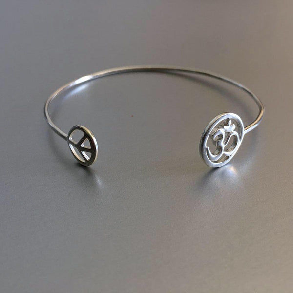 A beautiful melody: Peace charm with Om (infinity ) that evokes a rather spiritual air around you and the fashionista who follows the latest trends.  A striking sterling silver cuff.