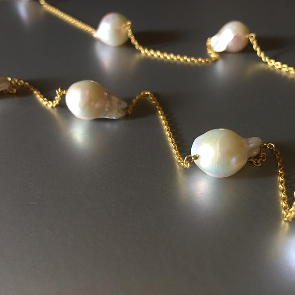 A beautiful twist on a classy pearl necklace, the weight is beautifully balanced by the equal amount of pearls on each side.
