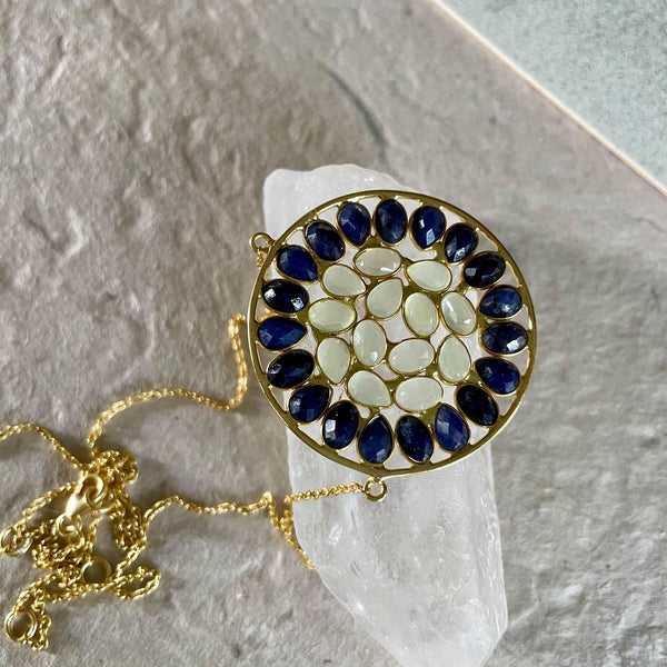 Simply Exquisite & Refined!   Wear it close to the collar bone or take it to its longest length of 20 inches, adjustable rings on this necklace make your wear both comfortable and convenient. An impeccable necklace with both oval and pear-shaped prehnite and blue sapphire gemstones that are 6x4 mm in size and carry a total weight of 19.34 ct. The dazzling medallion is 1 1/2 inches in diameter.