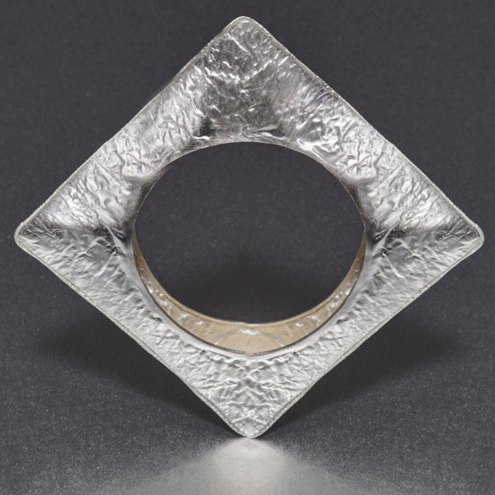 A fashionista's favorite: A hand-hammered, NO weight bracelet in an unusual square design that is perfect for that fashionista, ramp look. A bold, statement appeal that this bracelet exudes is beyond ones' imagination.  Wear it single or stack them up with rose gold and gold ones and flaunt an exclusive style and flair of your own.