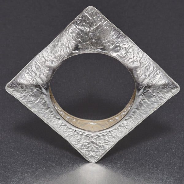 A fashionista's favorite: A hand-hammered, NO weight bracelet in an unusual square design that is perfect for that fashionista, ramp look. A bold, statement appeal that this bracelet exudes is beyond ones' imagination.  Wear it single or stack them up with rose gold and gold ones and flaunt an exclusive style and flair of your own.