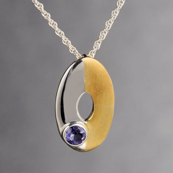 Cute dainty pendant with 2mm Iolite gemstone is mesmerizing! It is too cute to wear it, it should be held in your palms and you could look at it all day. Two tone sterling silver pendant is a perfect example of minimalist jewelry. 18Kt.gold plated on half the pendant adds character and style.