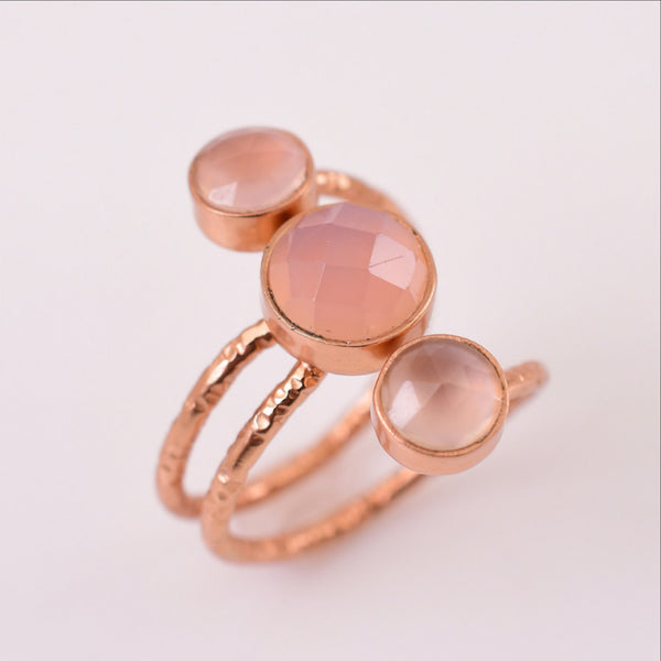 An adjustable, hand hammered textures rose gold ring, adorned with 3 beautiful rose quartz gemstones. Lightweight and flexible, this trendy ring can easily be adjusted to the fit you may need.