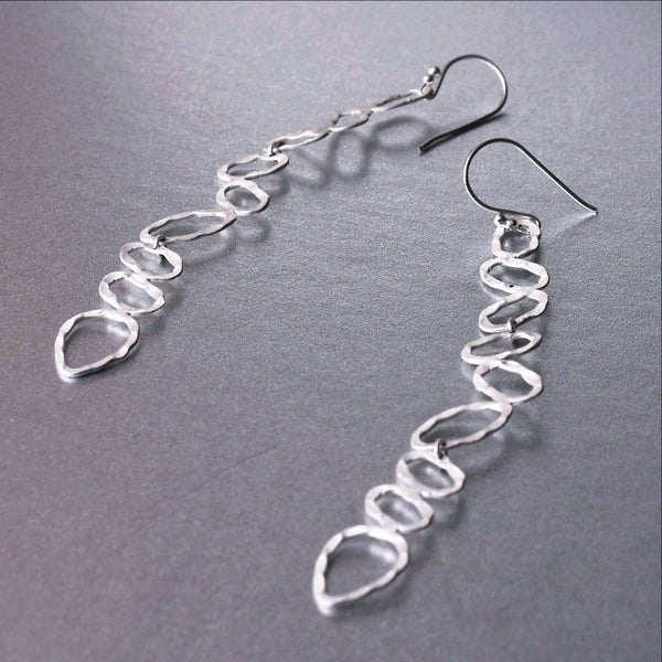Sterling silver, featherweight, chic and trendy earrings are quite deceiving. You may just forget that you had them on all day. An elongated and preppy shape that will spruce any attire.