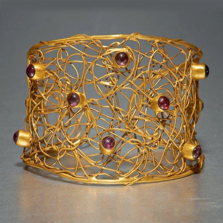 Simply Exquisite. Handmade, sterling silver base with 18kt. gold plating, this cuff is luxury at its best, a flawless and incomparable piece of jewelry. Amethyst gemstones dance freely thereby leaving behind that first impression that you will never ever forget. Limited Edition Piece.