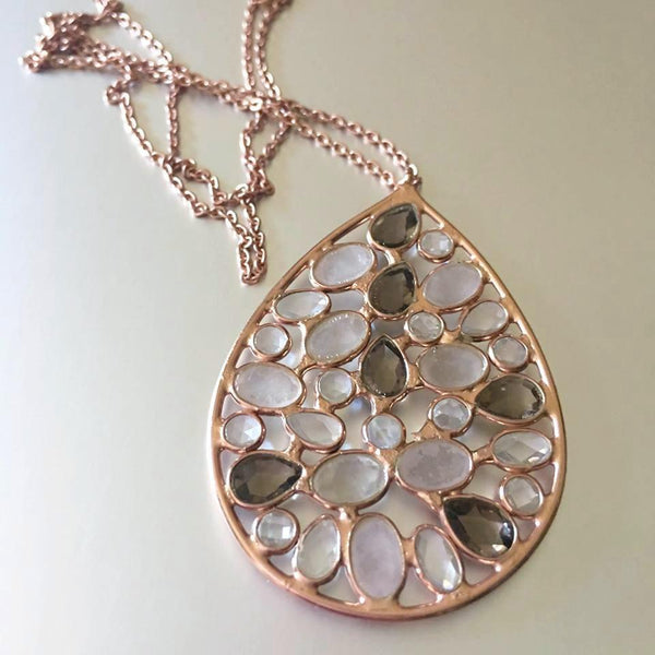 Simply flawless. A simple, teardrop design accentuating pink chalcedony, smoky quartz, and clear quartz is the latest addition to Mia Siya's Spring Collection. A pendant necklace that is loved for its classic, evergreen appeal and the ease of pairing it with casual as well as formal attire.