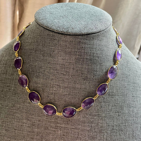 25.56 gms of total weight, this unique 9-inch amethyst necklace in brass with gold plating is mesmerizingly beautiful. Unshaped 19 amethyst strung together with poise and finesse.  With 97.600 gms total weight of amethyst, it is a sheer luxury that one must possess. 