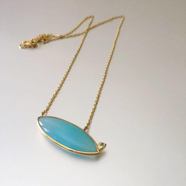 This chalcedony embedded pendant at a slant position makes it rather more captivating than what one would expect. Delicate, dainty and versatile in wear for an everyday look