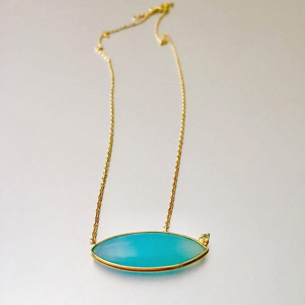 This chalcedony embedded pendant at a slant position makes it rather more captivating than what one would expect. Delicate, dainty and versatile in wear for an everyday look.