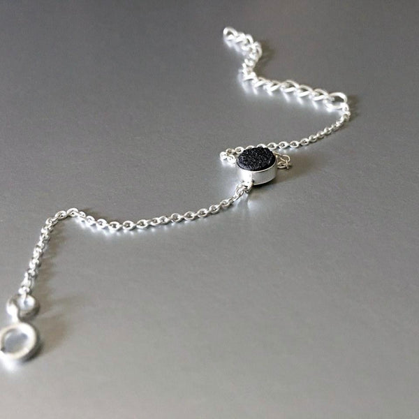  An adjustable, dainty, lightweight, sterling silver bracelet with stunning sparkling black druzy adds an artful addition to your everyday look.