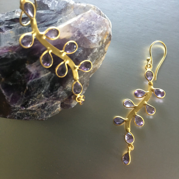 Looks can be deceiving! The saying can easily be used for these stunning Sanya Earrings with amethyst. Lightweight, delicate yet durable and bold, these playful earrings showcase amethyst gemstones so graciously that one may not imagine