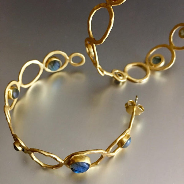 One of my personal favorite to look at since I can't wear anything more than a stud. A lover of jewelry, especially earrings but can't wear it but you can. Enjoy these stunning gold plated semi-hoop, enhanced with my favorite gemstones: labradorite. What can be more breathtakingly beautiful than that combination?