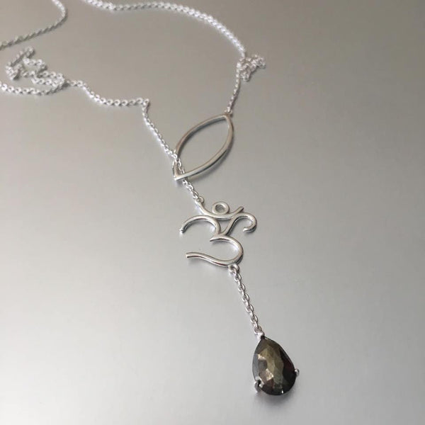 The most unusual design from the new collection: The lariat necklace. What better choice of pendant and charm than an "OM" with a smoky quartz gemstone. The delicate sterling silver chain goes through gracefully via the petal thereby exuding elegance and perfection of the OM