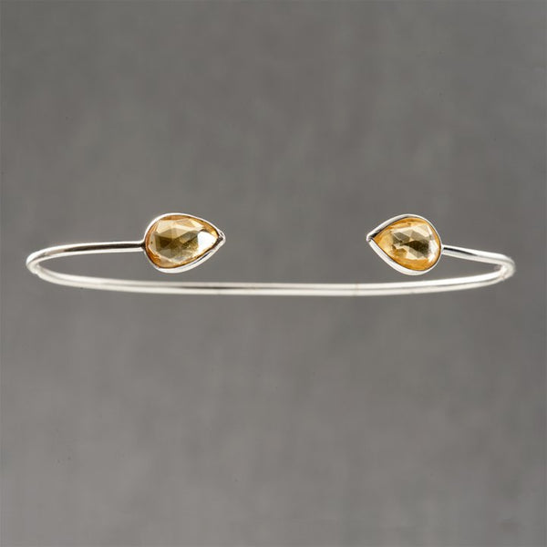 Sterling silver delicate cuff with yellow quartz may seem simple yet is an exquisite and classic piece of jewelry. Topaz is a stone to manifest your intentions, in alignment with Divine Will. This beautiful stone is a November birthstone. The energy of this stone attracts helpful people into your life that will benefit you, and may bring new friendships.