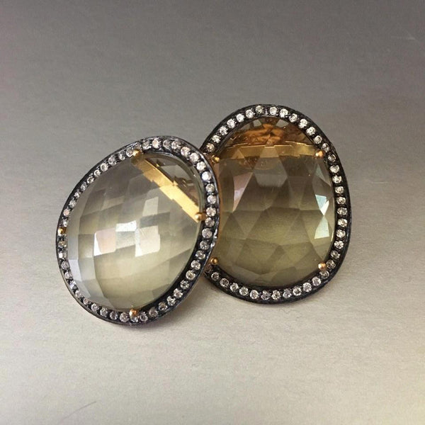 An exquisite pair of earrings that connect to your heart and soul with your first glance. A stunning yellow topaz earring studs, with cute little cubic zirconia circling the stud so harmoniously.