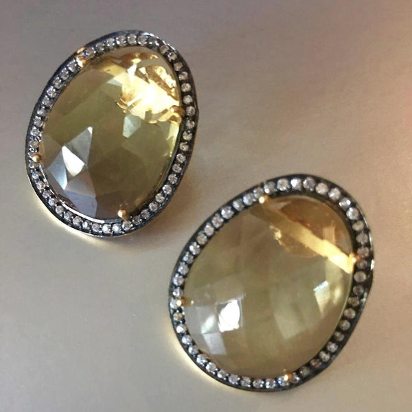 An exquisite pair of earrings that connect to your heart and soul with your first glance. A stunning yellow topaz earring studs, with cute little cubic zirconia circling the stud so harmoniously.