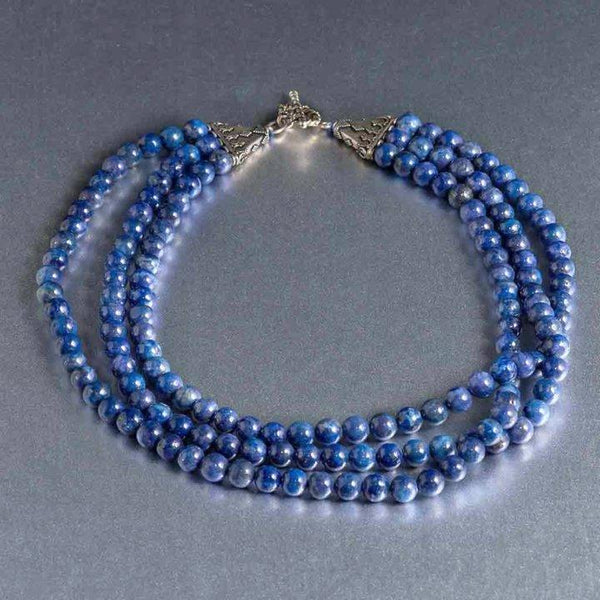 This gorgeous multi-strand lapis lazuli necklace simply exudes elegance and a classy appeal. It holds deep blue 8 mm lapis lazuli gemstones with beautiful variations of color and rich striations of pyrite running through it is and is strung together with a sterling silver 3 prong sturdy toggle clasp. The necklace is 17 ½” at its shortest strand to 20” at its longest hanging last layer. 